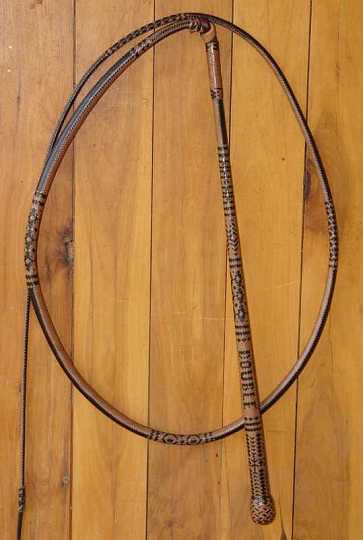 DT Double-1.jpg - 32 x 24plait 6ft 6in Australian stock whip placed second at the 2005 "Australian Plaiting Championships" at Glen Innes. This whip has the words DOUBLE TROUBLE plaited into opposing sides of the handle  with some other very inticate pattern work in the handle and thong .